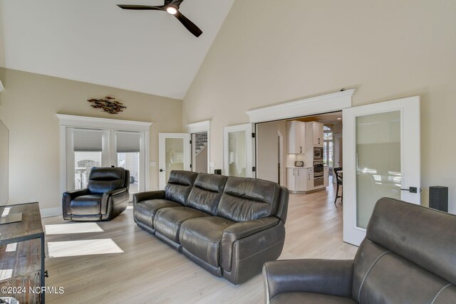 kitchen featuring stainless steel appliances, white cabinetry, pendant lighting, and light stone counters