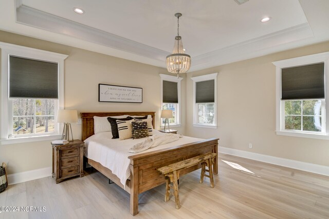 kitchen featuring decorative backsplash, stainless steel appliances, white cabinets, and light wood-type flooring