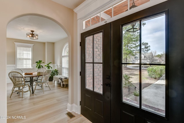 foyer entrance with light hardwood / wood-style flooring and french doors