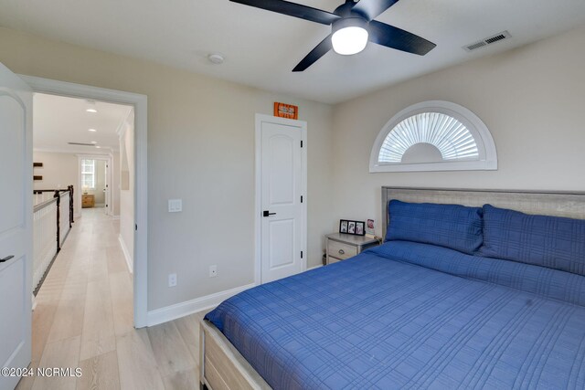 bathroom featuring vanity, hardwood / wood-style floors, a bathtub, and ornamental molding