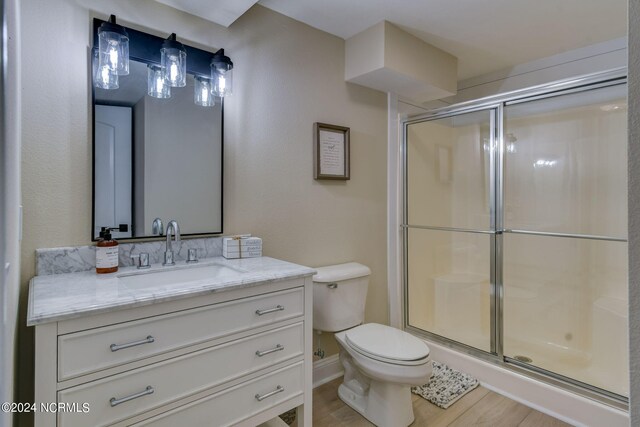 bathroom with hardwood / wood-style flooring, vanity, and ceiling fan