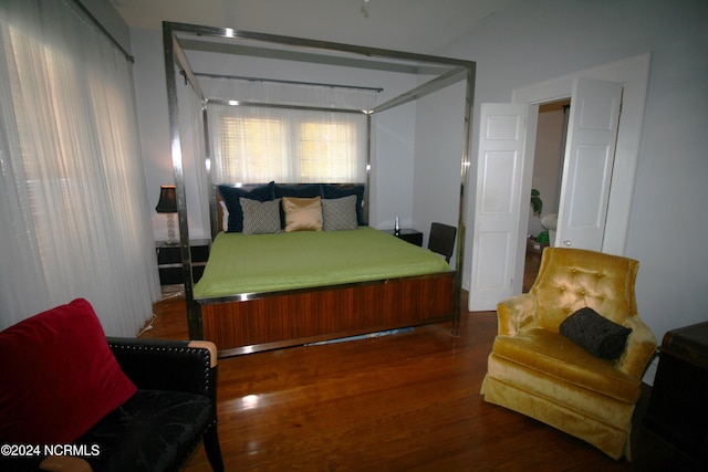 bedroom with dark wood-type flooring