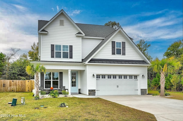 view of front facade featuring covered porch, a garage, and a front lawn