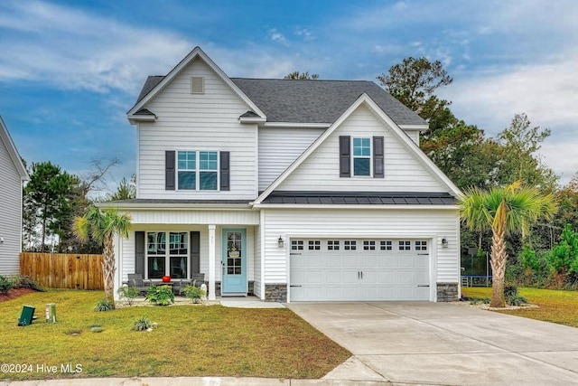 view of front of property with a front yard and a garage