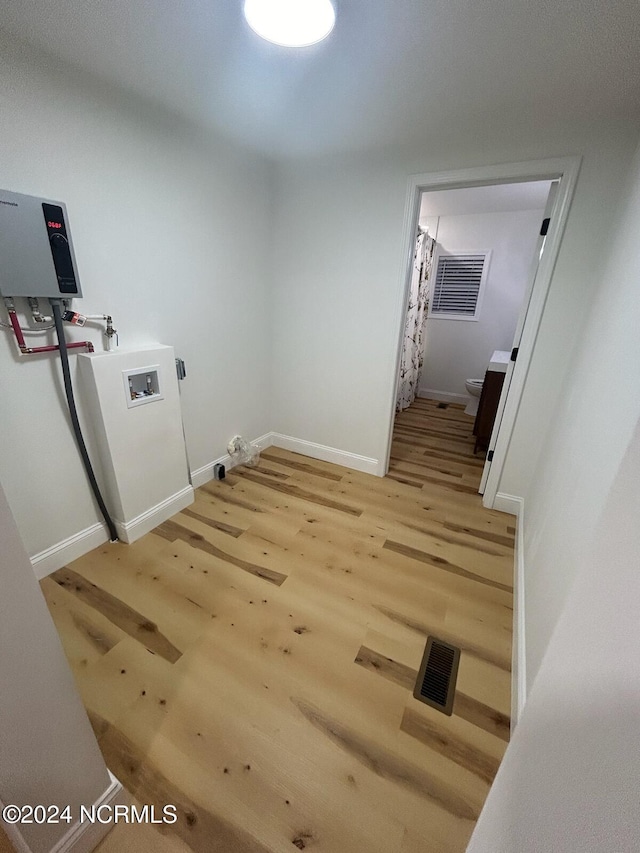 laundry room with hookup for a washing machine and light wood-type flooring