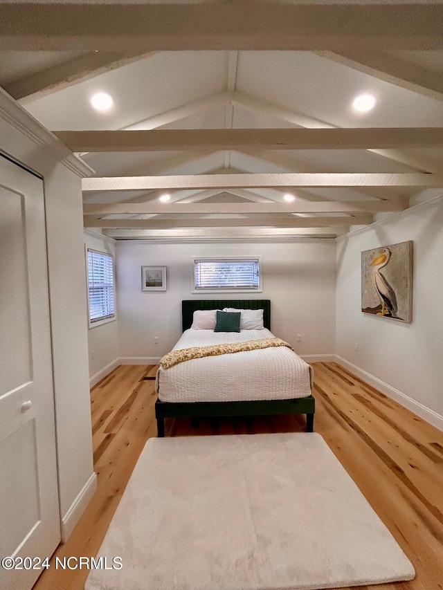 bedroom with hardwood / wood-style floors and lofted ceiling with beams