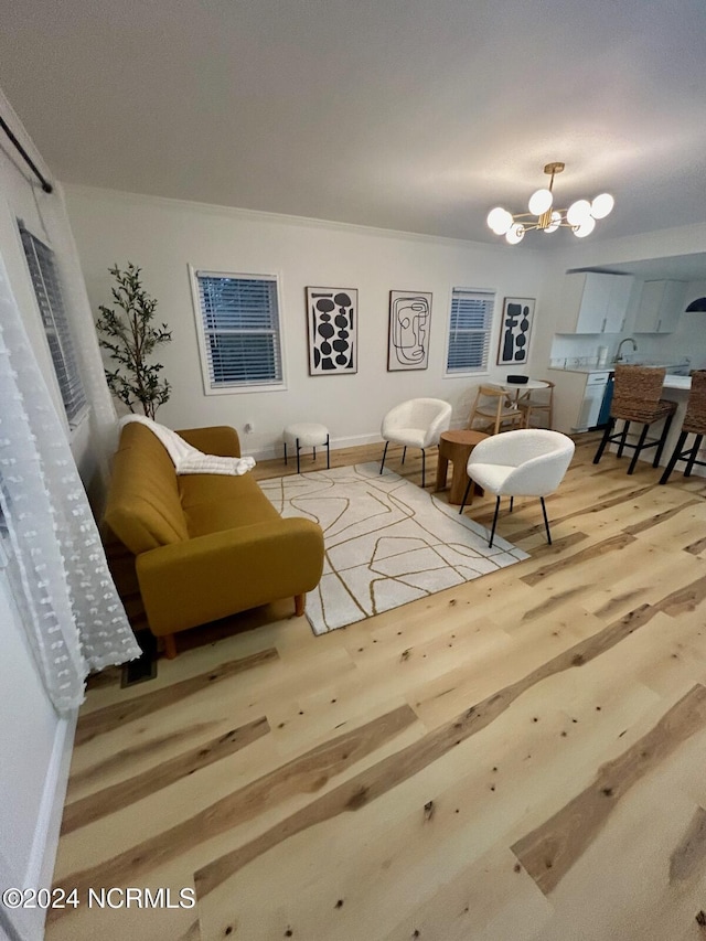 living area featuring wood finished floors and a chandelier
