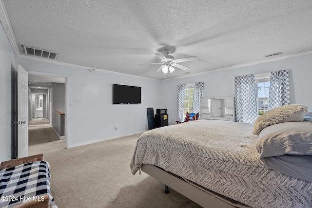 carpeted bedroom featuring multiple windows, ceiling fan, and crown molding