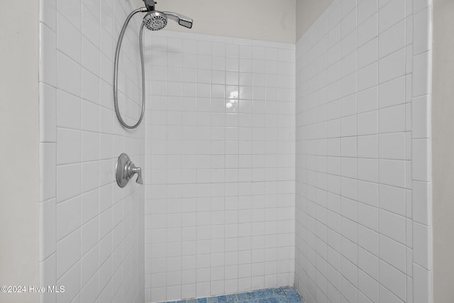 bathroom with tiled shower