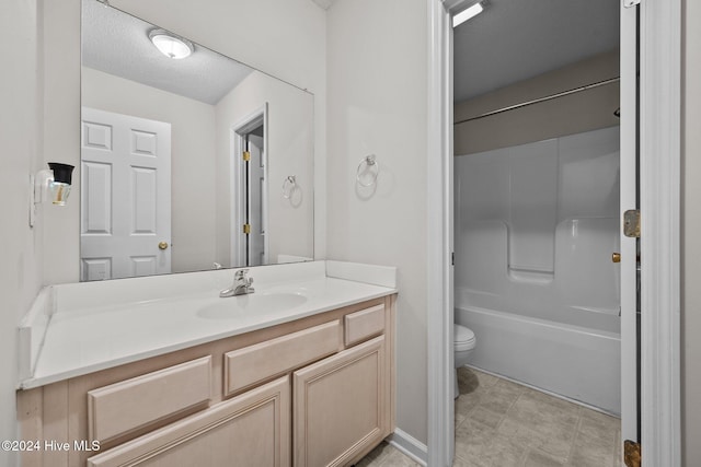 full bathroom with vanity, shower / bathtub combination, toilet, and a textured ceiling