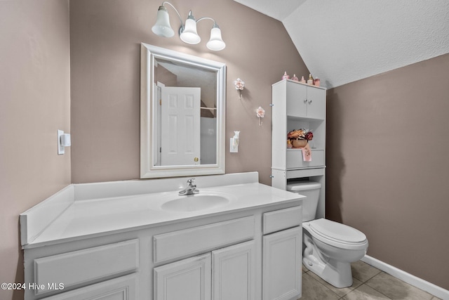 bathroom featuring tile patterned flooring, vanity, toilet, and vaulted ceiling