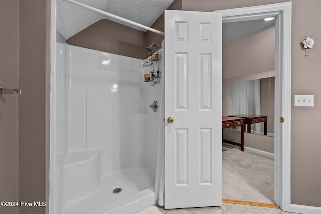 bathroom featuring tile patterned floors, a textured ceiling, and walk in shower