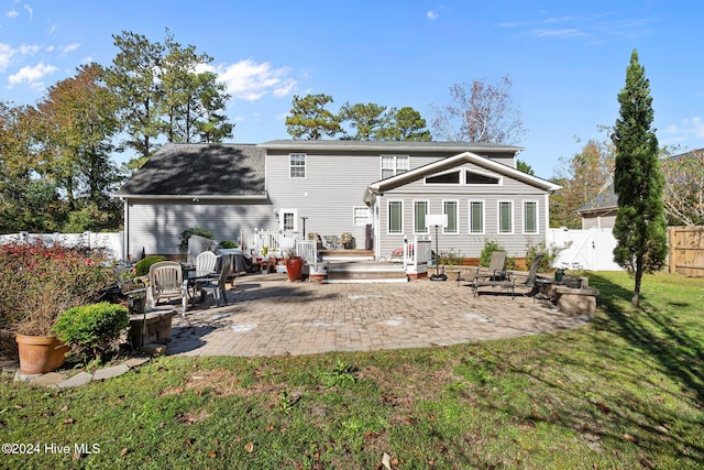 back of house featuring a yard and a patio