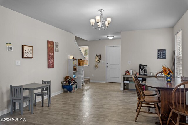 dining area with a notable chandelier and hardwood / wood-style flooring