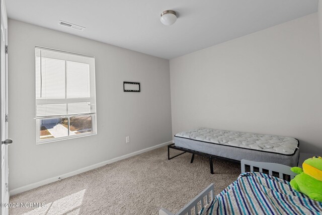 bedroom with light carpet