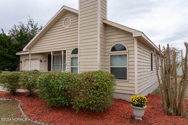 view of side of home with a garage