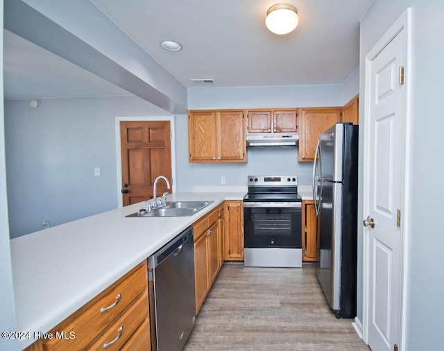 kitchen with stainless steel appliances, light hardwood / wood-style flooring, and sink