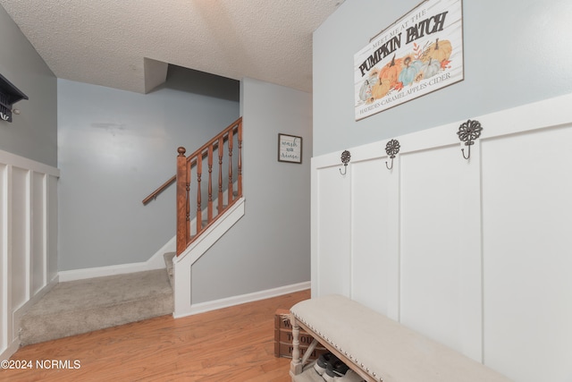 mudroom featuring light hardwood / wood-style floors and a textured ceiling