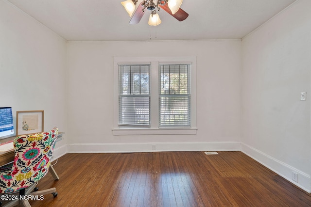 unfurnished office featuring hardwood / wood-style flooring, ceiling fan, and crown molding