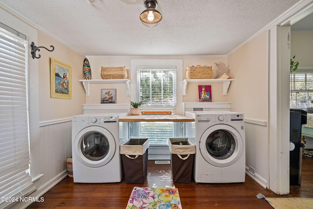 laundry room featuring a textured ceiling, dark hardwood / wood-style flooring, ornamental molding, and a healthy amount of sunlight