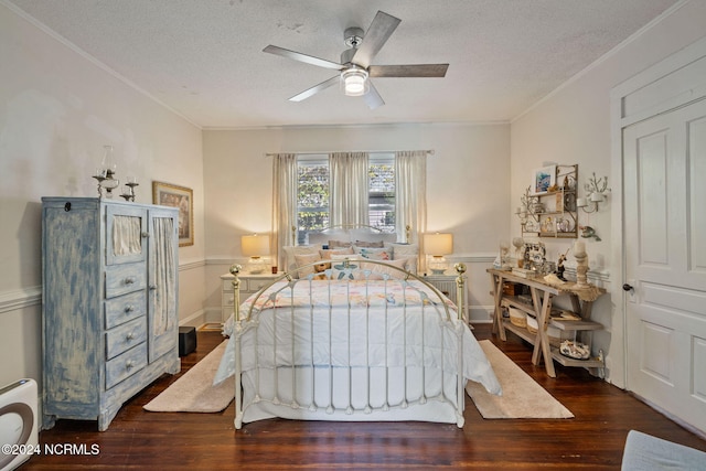 bedroom with a textured ceiling, ceiling fan, and dark wood-type flooring