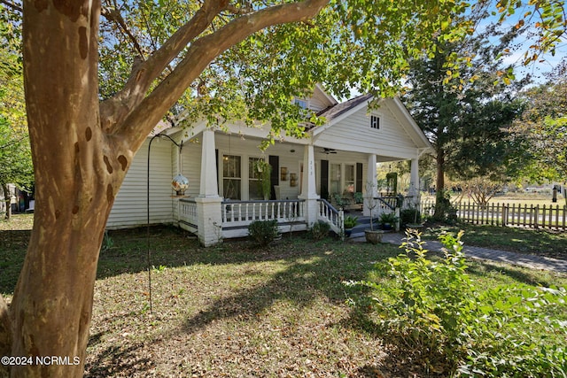 view of front of property with a front yard and a porch