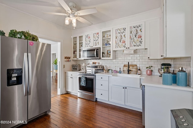 kitchen with white cabinets, decorative backsplash, dark wood-type flooring, and appliances with stainless steel finishes