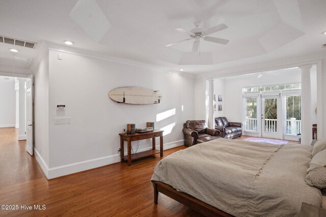 bedroom featuring a tray ceiling and crown molding