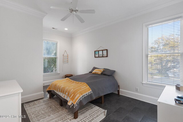 bedroom with ceiling fan, dark tile patterned floors, and ornamental molding