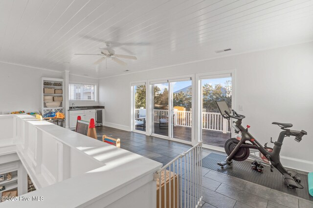 recreation room with built in shelves, ceiling fan, beverage cooler, and wood ceiling