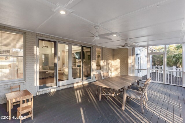 sunroom featuring a wealth of natural light and ceiling fan