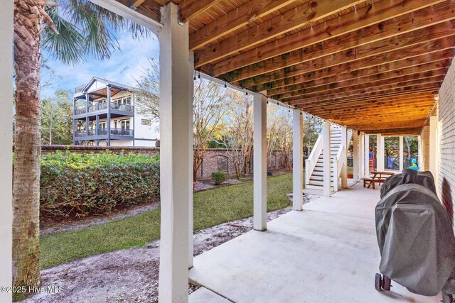 exterior space with a sunroom, a patio, and a wooden deck