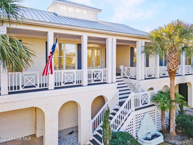 wooden terrace with a porch and french doors