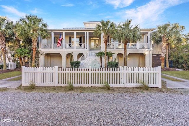 view of front of property featuring a porch, a balcony, and a garage