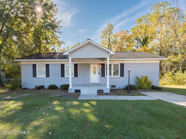 ranch-style home featuring a porch and a front yard