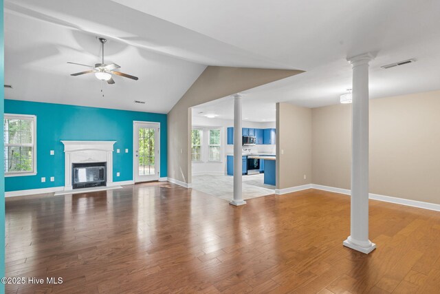 8525 Primm Forest Dr, Leland, NC 28451 - unfurnished room featuring lofted ceiling, ceiling fan, ornate columns, and wood finished floors