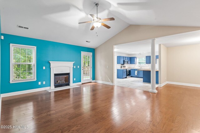 8525 Primm Forest Dr, Leland, NC 28451 - unfurnished living room with a premium fireplace, vaulted ceiling, ornate columns, and ceiling fan