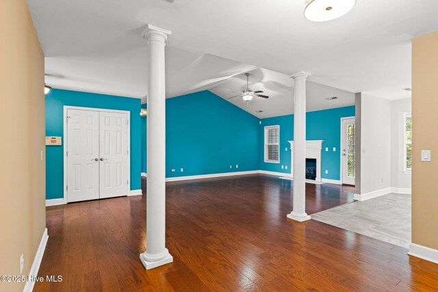 8525 Primm Forest Dr, Leland, NC 28451 - unfurnished living room with vaulted ceiling, ceiling fan, ornate columns, and wood finished floors