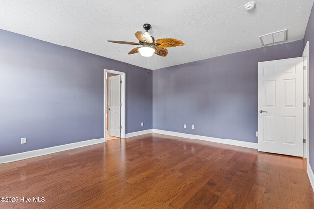 8525 Primm Forest Dr, Leland, NC 28451 - empty room with ceiling fan, wood finished floors, a textured ceiling, and baseboards