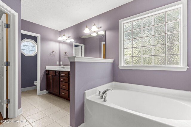 8525 Primm Forest Dr, Leland, NC 28451 - bathroom featuring a sink, a textured ceiling, and tile patterned floors