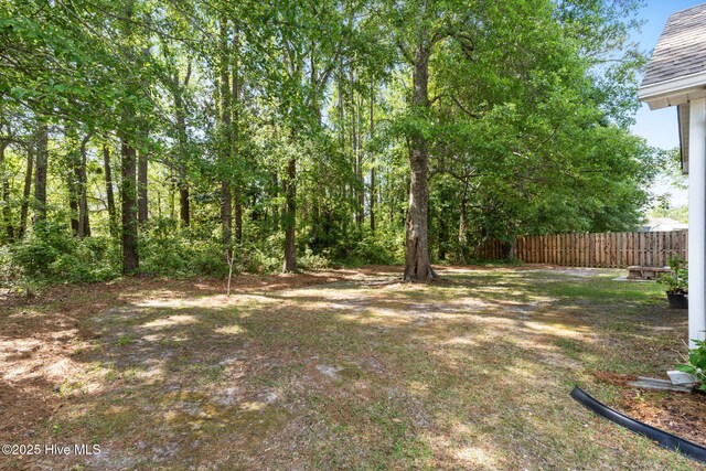 8525 Primm Forest Dr, Leland, NC 28451 - rear view of house with fence and a fire pit