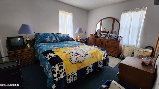 carpeted bedroom with a textured ceiling