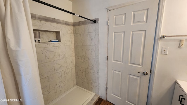 bathroom featuring vanity, hardwood / wood-style flooring, and walk in shower