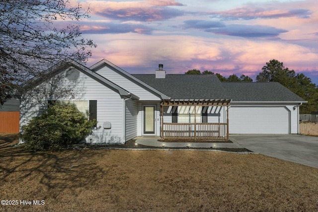 view of front of home with a lawn and a garage