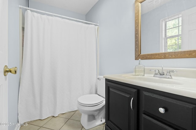 bathroom featuring toilet, tile patterned floors, and vanity