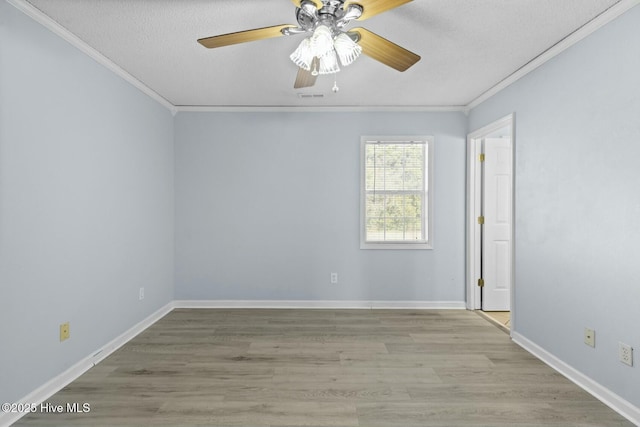 spare room featuring ceiling fan, a textured ceiling, light hardwood / wood-style flooring, and crown molding