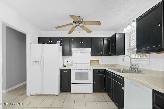 kitchen with exhaust hood, light tile patterned floors, white appliances, a textured ceiling, and sink