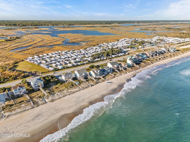 drone / aerial view with a water view and a view of the beach