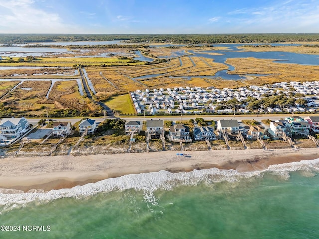 drone / aerial view with a water view and a beach view