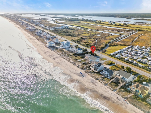 birds eye view of property featuring a water view and a view of the beach